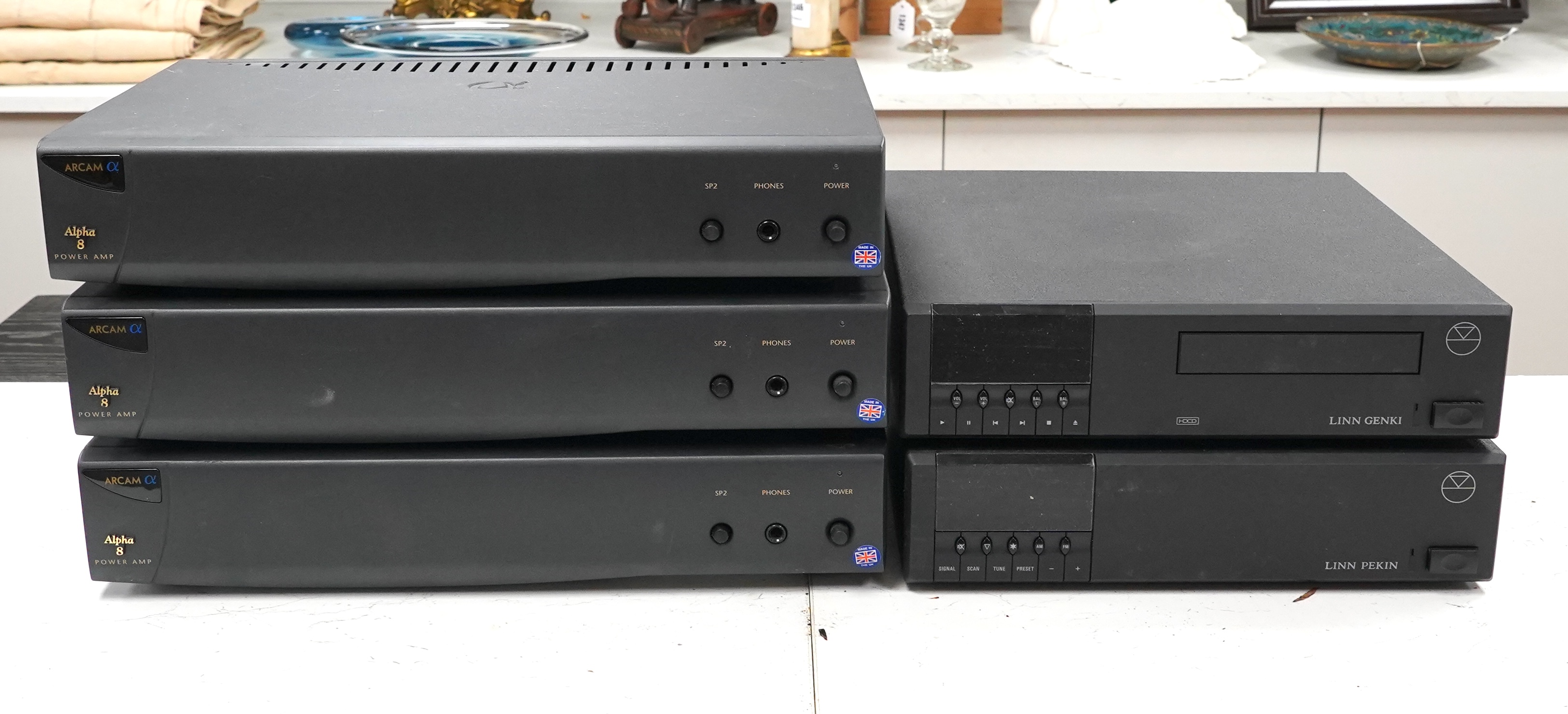A Linn Pekin tuner, a Linn Genki CD player and three Arcam Alpha 8 Power Amps, with three remote controls, two power cables and instructions for the amplifiers
